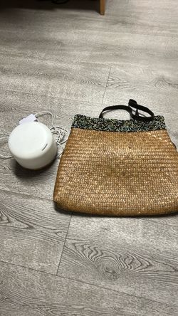 A diffuser and Woven Straw Tote Bag with Beaded Trim