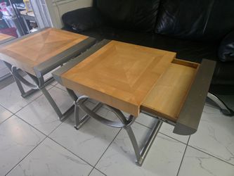 Center table along two side tables .