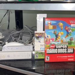 Wii With 2 Remotes + Nunchuck And Super Mario Bros , Wii sports And Wii sports Resorts