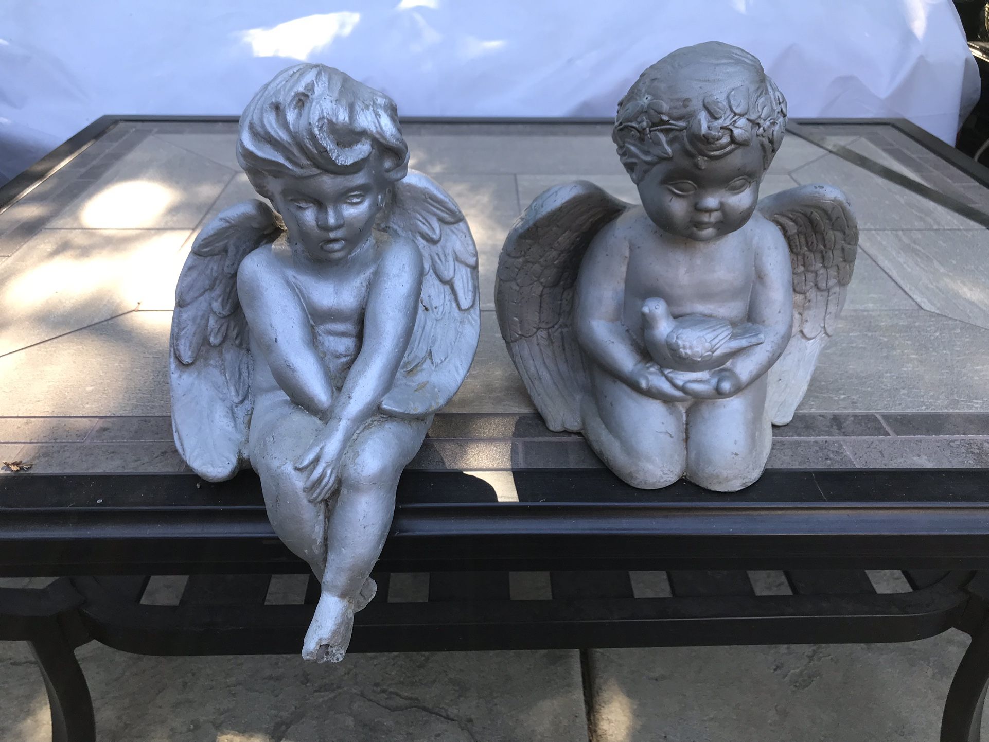 A pair of cute cherubs garden statues