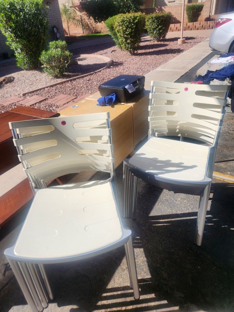 White Chairs. Metal Frame With Plastic Seat and Plastic backing.