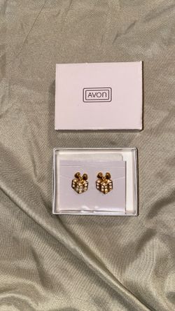 This is a pair of vintage Avon "Sparkling Package" gold-tone and rhinestone pierced earrings from 1992. 
