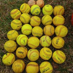 Preowned bunch of baseballs and softballs