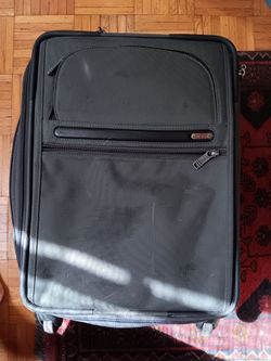 TUMI black carry-on suitcase