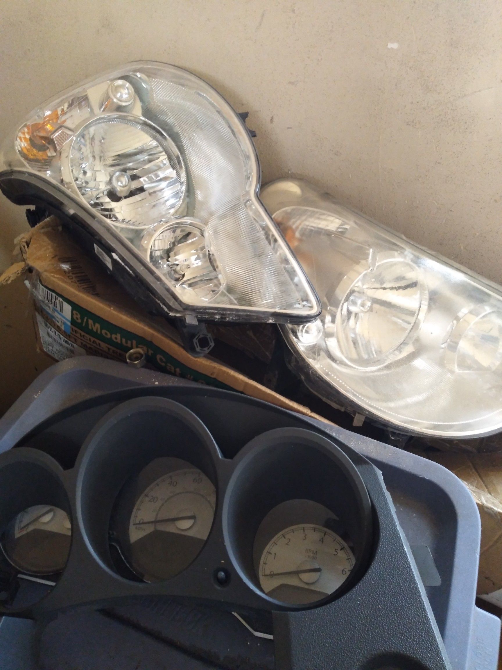 I have two headlights a brand new fender and a cluster for a Chrysler Sebring for sale