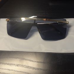 Miu Miu black sunglasses with gold accents 