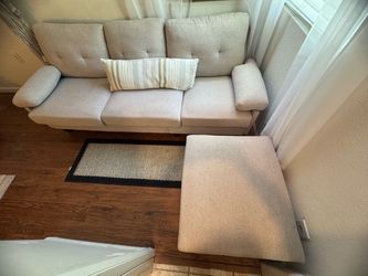 Light grey sofa with ottoman with side pocket