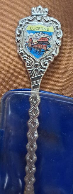 This souvenir spoon showcases a beautiful scene of Lucerne, Switzerland and is made of silverplate. 