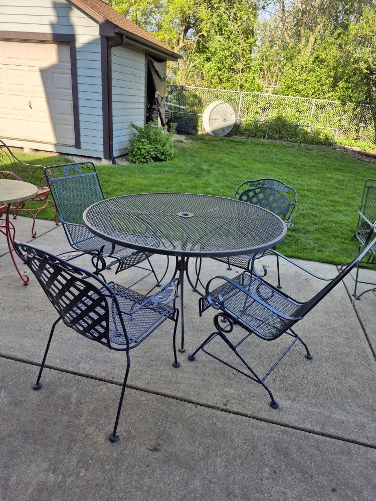 Solid Wrought Iron Patio Set, Table's H 30", W 48", Top Is Removable, 2 Rocking Chairs, 2 Stackable Chairs.