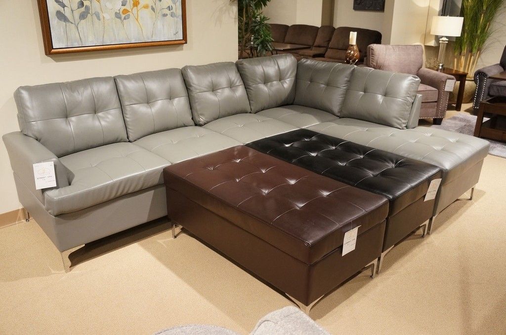 Brand new 110" x 80" grey leather sectional + ottoman