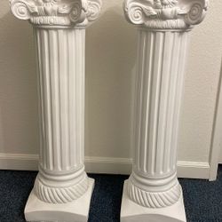 Two tall white pillars/columns