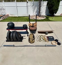 Home gym set up includes: barbell, sled, and bumper plates