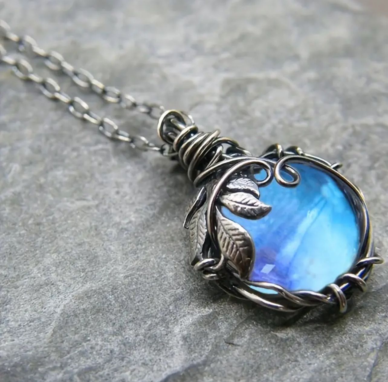 Elegant Blue Moonstone Pendant: Vintage charm, leaf winding, rope