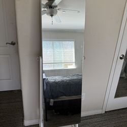 white standing mirror with jewelry cabinet