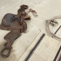 Saddle  With Blanket And Bits As Well As A Also