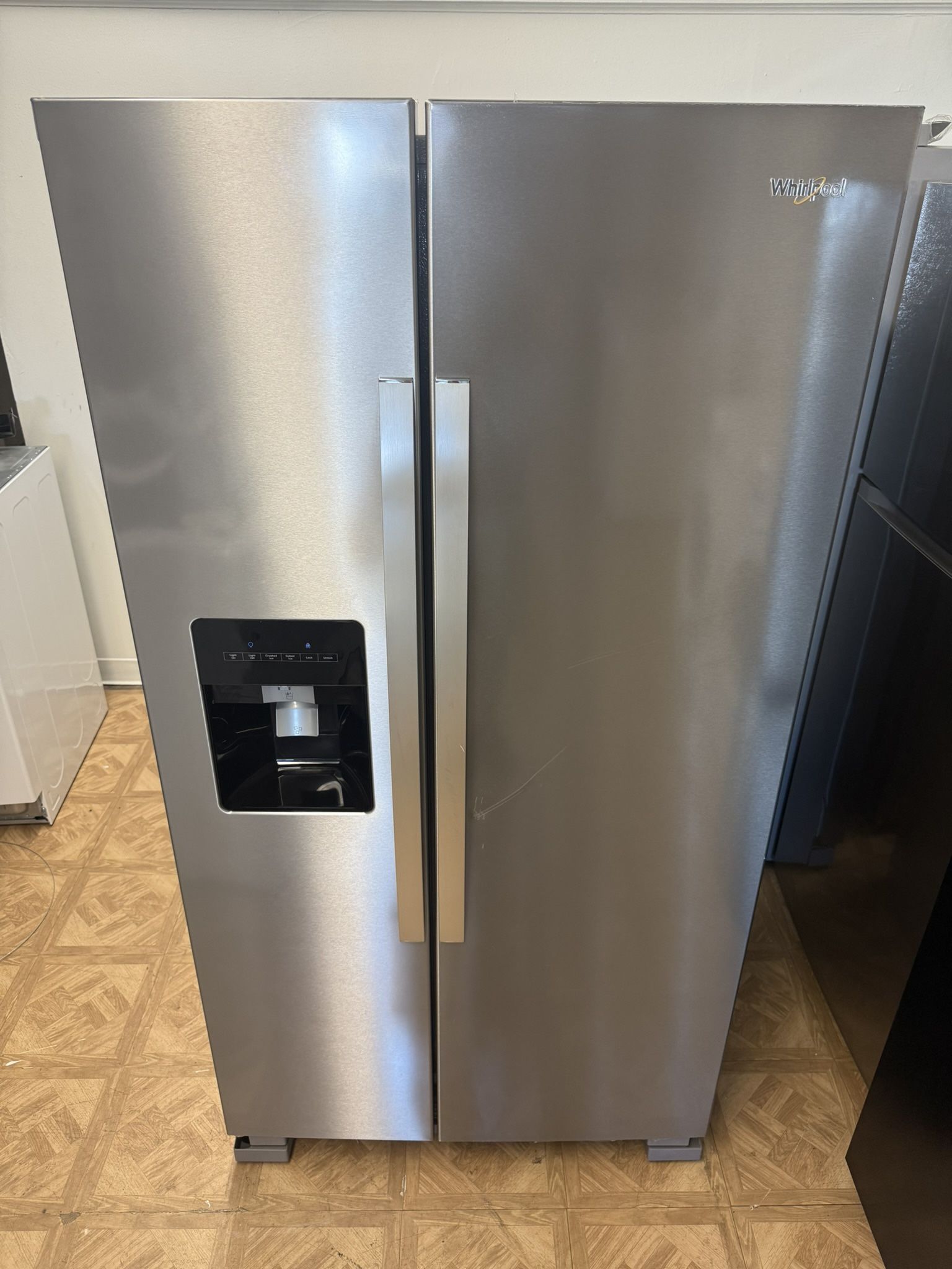 LIKE NEW WHIRLPOOL SIDE BY SIDE STAINLESS STEEL REFRIGERATOR .