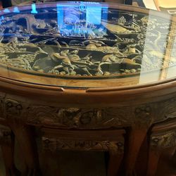 Chinese oval hand carved battling warriors coffee table with six stools