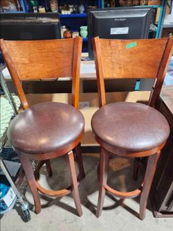 Pair of brown wood swivel stools with backs $35 ea