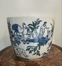 A modern take on the traditional white and blue Chinoiserie flower pot; features a drainage hole at the bottom.,7" H x 8" W.