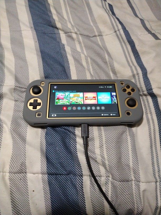 Nintendo Switch Lite (Hyrule Edition) with accessories & games