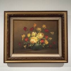 Beautiful original oil painting with vibrant yellow and red flowers in a vase. Has a lovely textured style. Comes in an ornate wood frame with gold ac