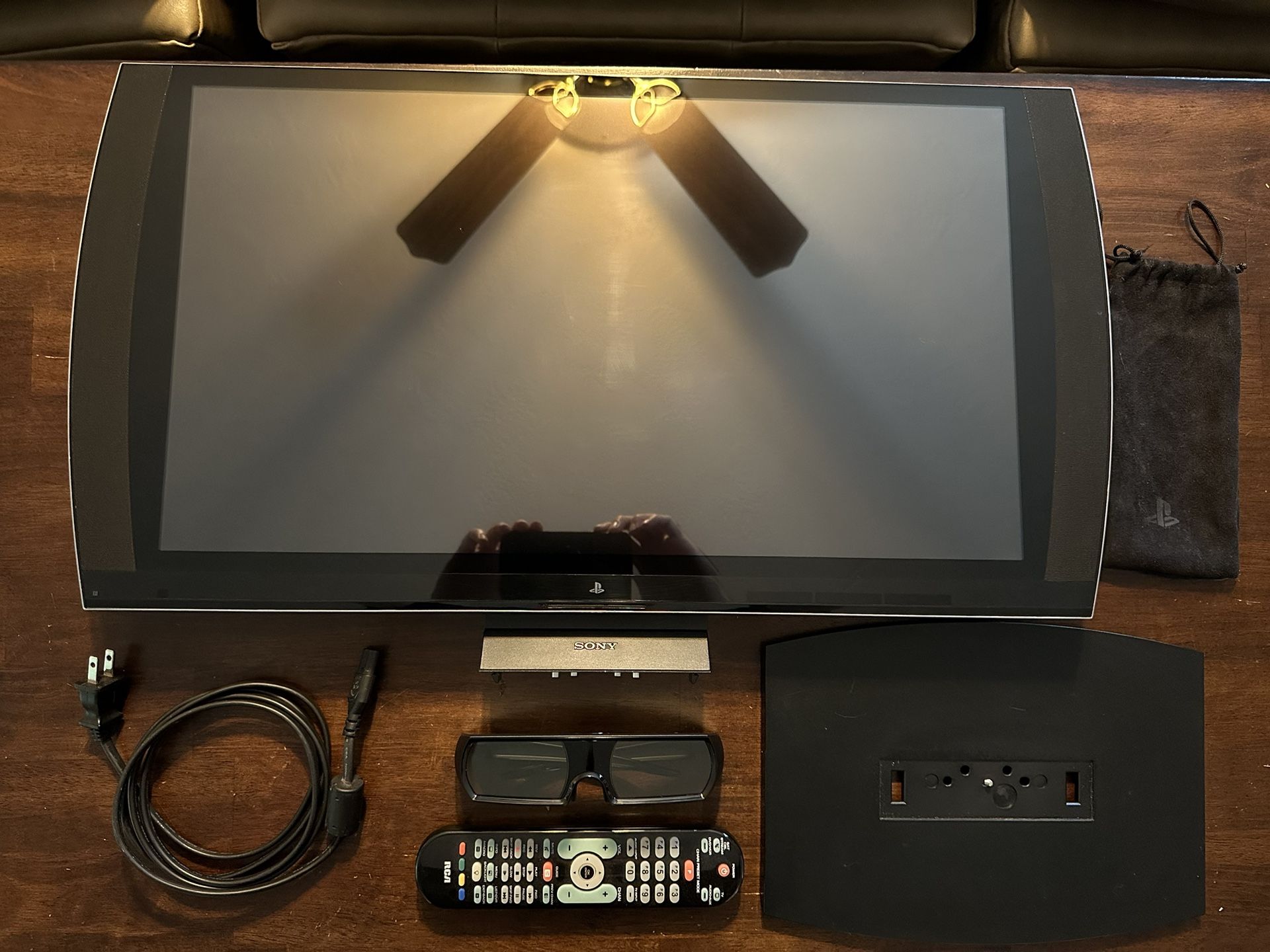 PlayStation 3D Display (24”) with 3D glasses, power cable, and universal remote programmed for it.