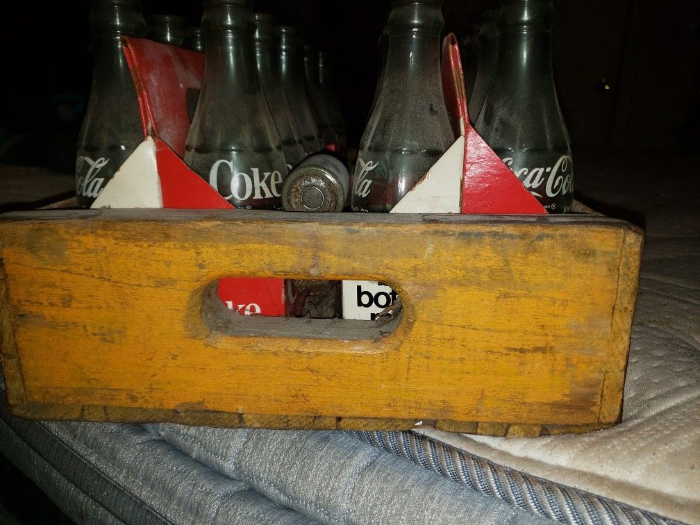 Vintage coke bottles and wooden case.
