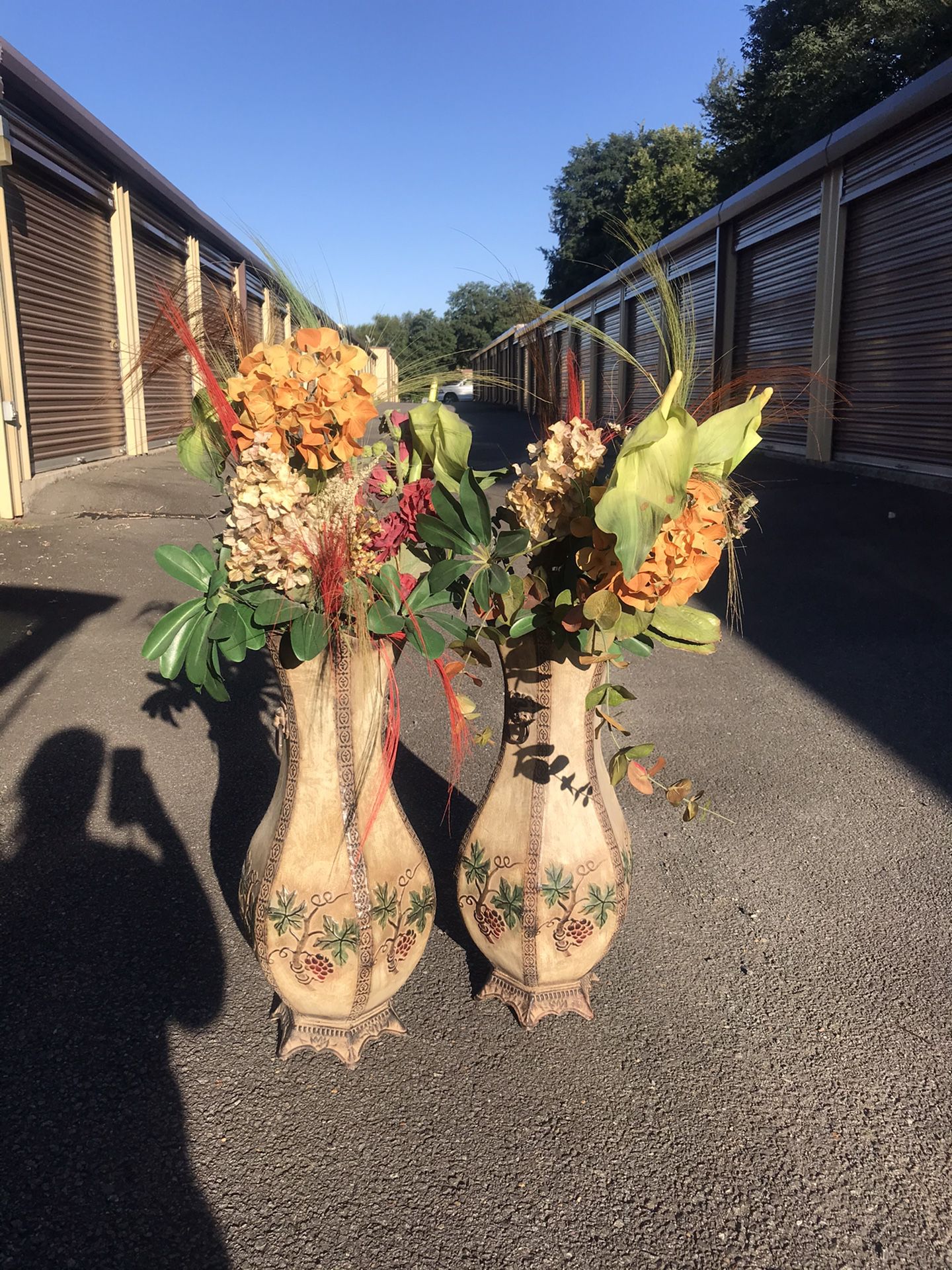 Faux flower arrangements with floor vases