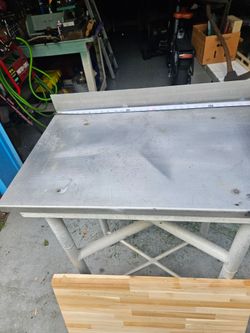 Aluminum,  frame with stainless steel top and butcher block top