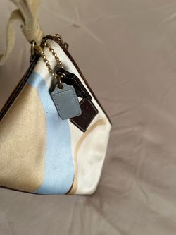 It’s very cute wallet made by coach