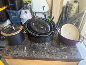 Several roasting pans, enamel oven dish, large cooking pot