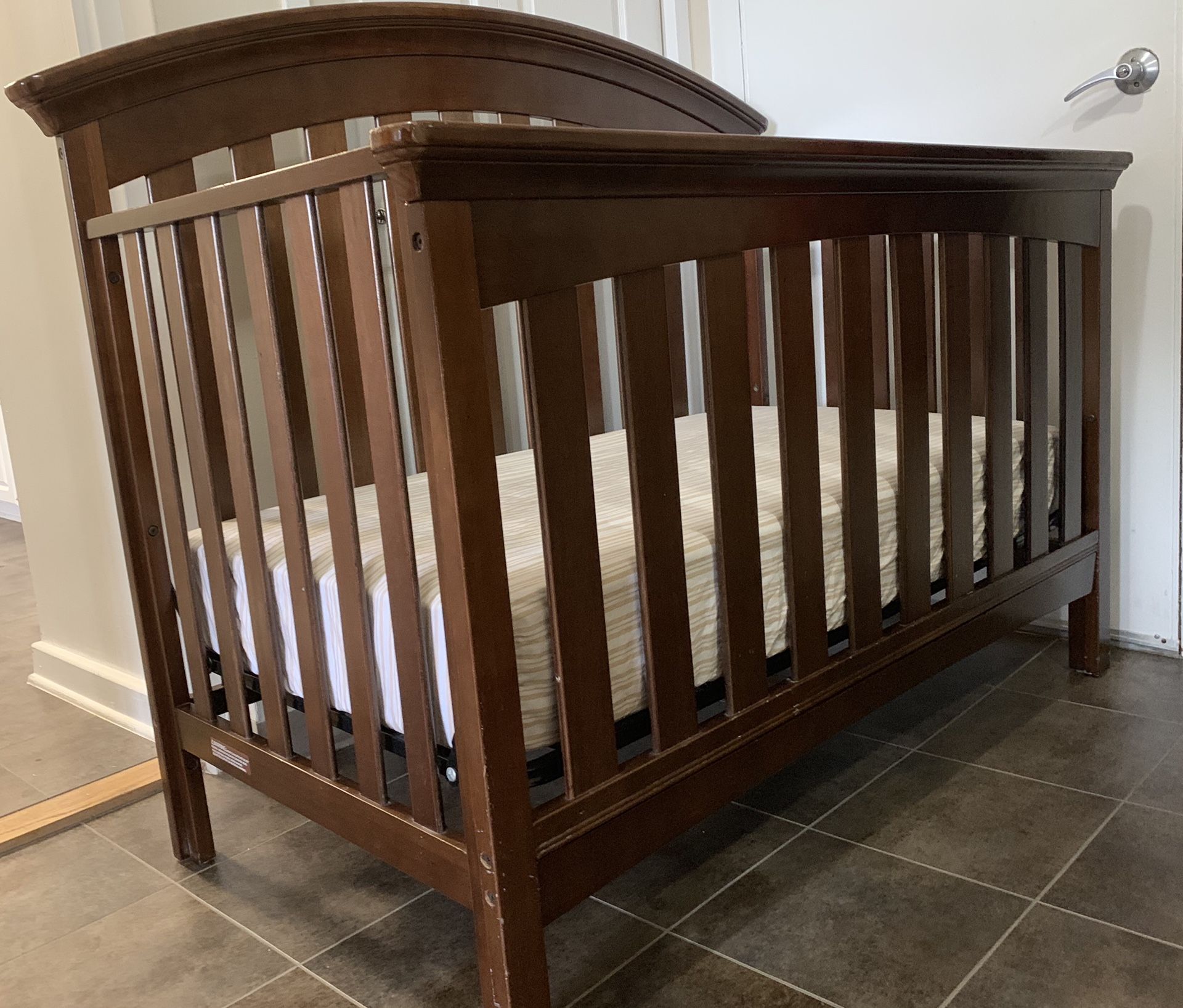 Baby’s brown wooden crib