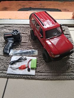 4x4 rc crawler has extra parts 2 batteries head lights  forward and reverse  ready to play firm price $50