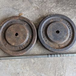 Two 50 lb. York metal weights with heavy duty lift bar.