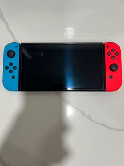 OLED Nintendo Switch with Blue and Red Controllers and Charger