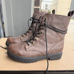 Combat boots with studded soles, laces, and side zipper