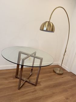 CB2 Silverado 47" Round Brass Dining Table + West Elm 80” Overarching Metal Shade Floor Lamp