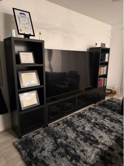 Couch and tv stand with book shelf