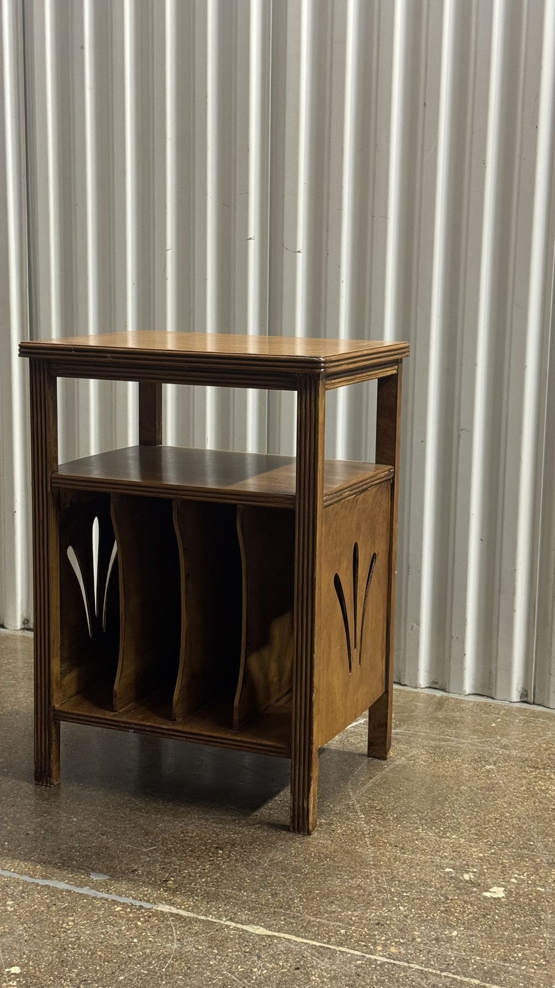 vintage art deco style mid-century modern end table with decorative side cut outs and vertically storage sections for records or magazines 