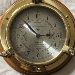 Bey-Berk International brass porthole tide and time clock with a wood base