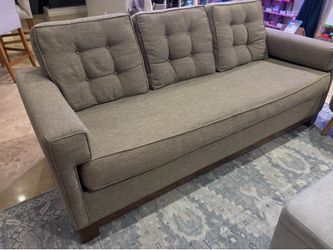 Beige tan couch with tufted back