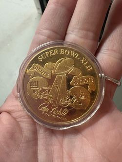 Super Bowl XLII Highland Mint 24kt Gold Overlay Medallion, which is a limited-edition collectible minted for the game played on Sunday, February 3, 20