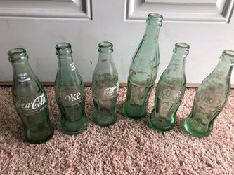 Six collectible Coca-Cola bottles