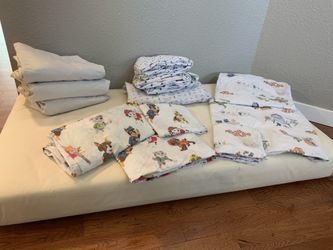 Naturepedic 2-stage Crib & Toddler Mattress, Naturepedic Mattress Covers, & Pottery Barn Sheet Sets (Paw Patrol & Finding Nemo)