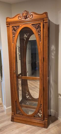 Tall lion curio display cabinet.