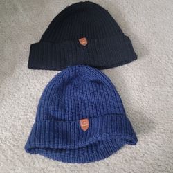 Two blue and black Coach men’s winter hats, made from 100% wool with cow leather trim. $40 each.