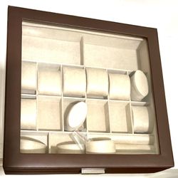 wooden watch display case with a glass lid and multiple compartments for storage and display. 