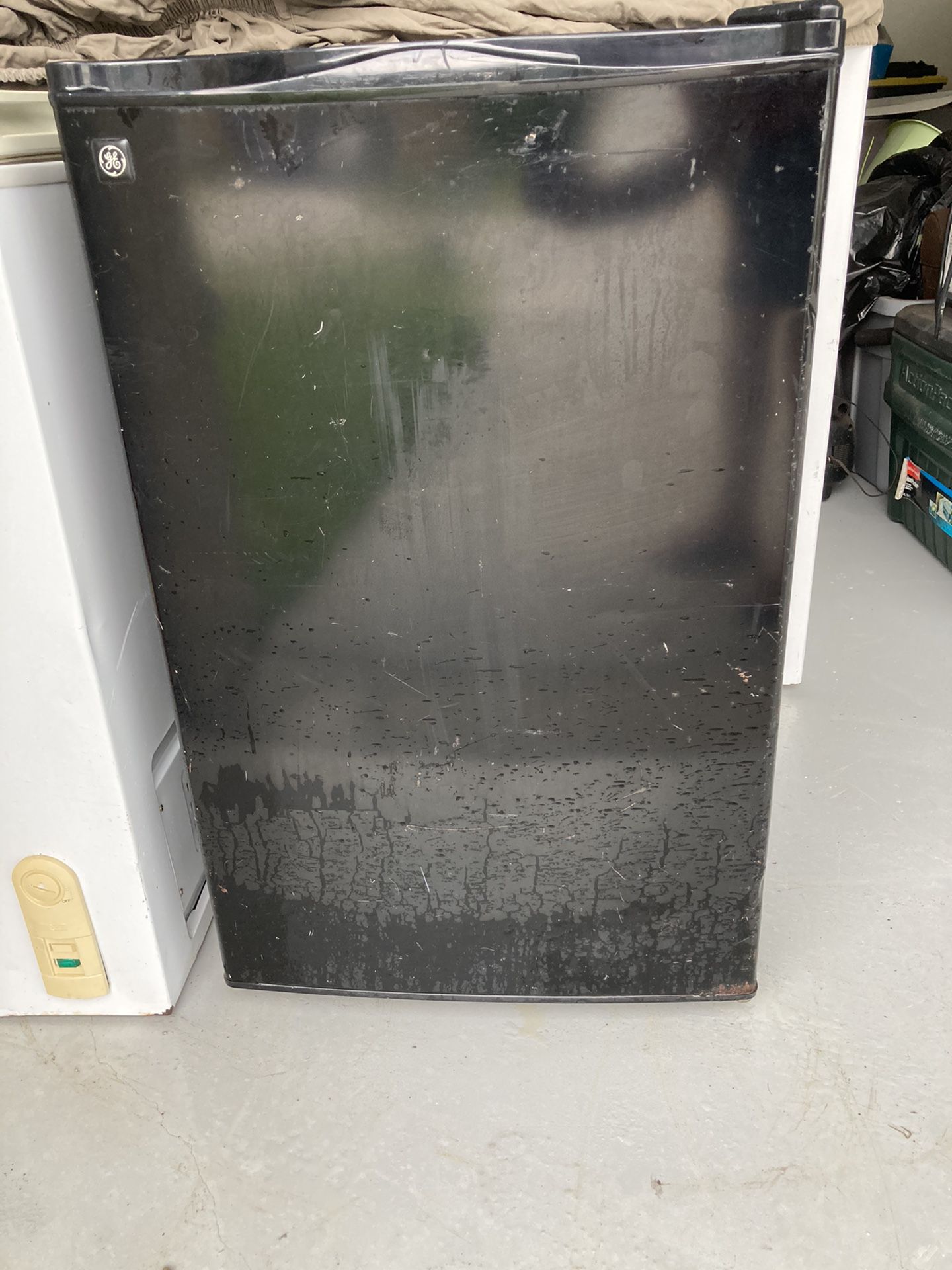 Small black refrigerator works great looks rough