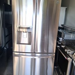 Kenmore refrigerator, 36 inches wide by 68 and a half inches tall and 24 inches deep. It has an ice maker and a water dispenser.