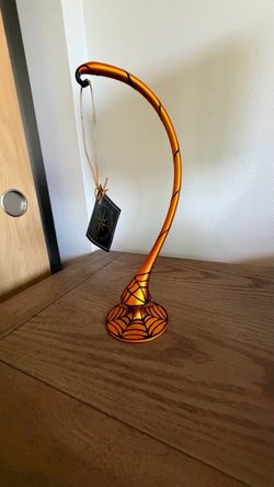 Set of 2 Christopher Radko mint condition 12” Halloween glass ornament stand and Radko 12” Red glass ornament stand mint condition as well.